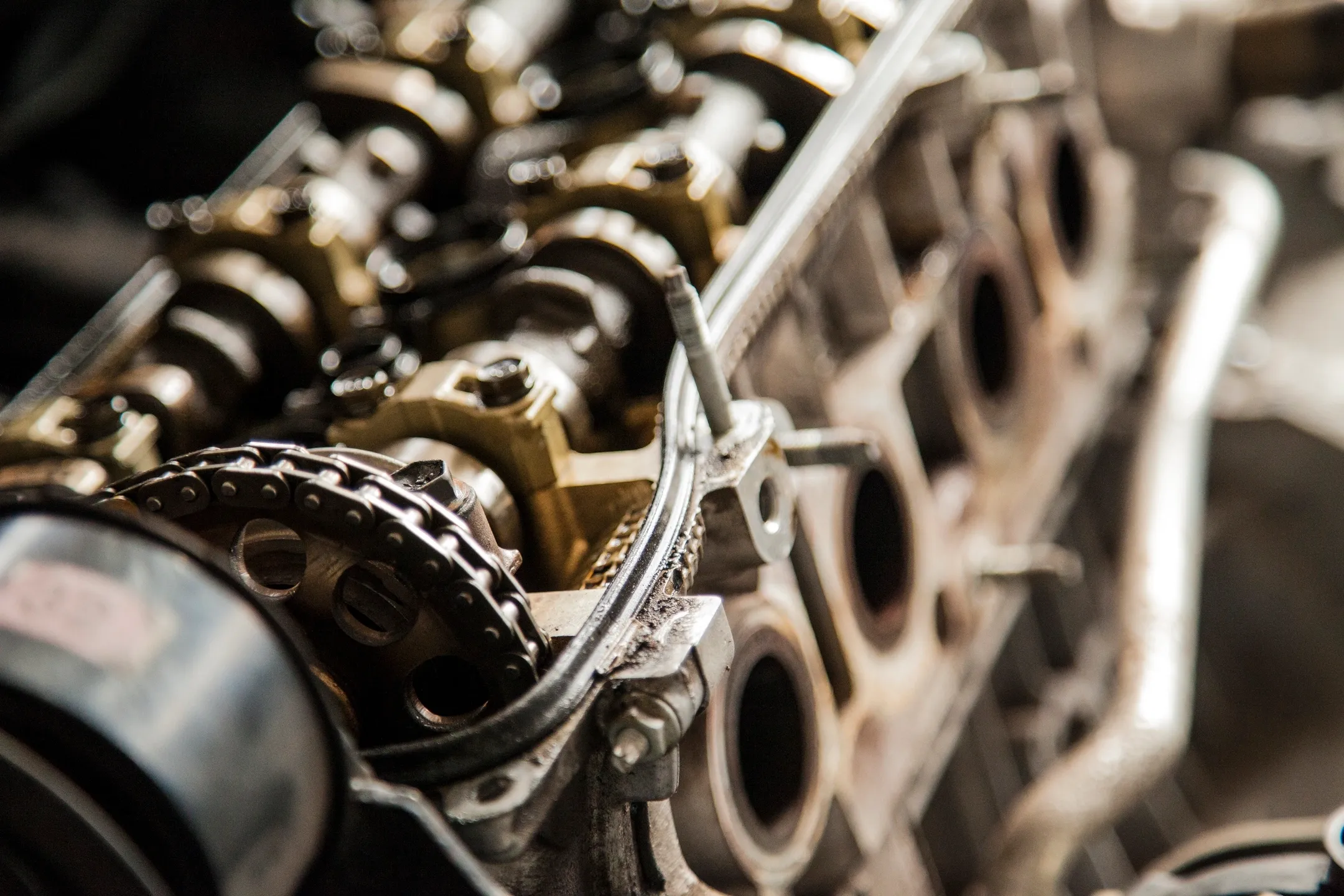 A close up of the engine block of an old car.
